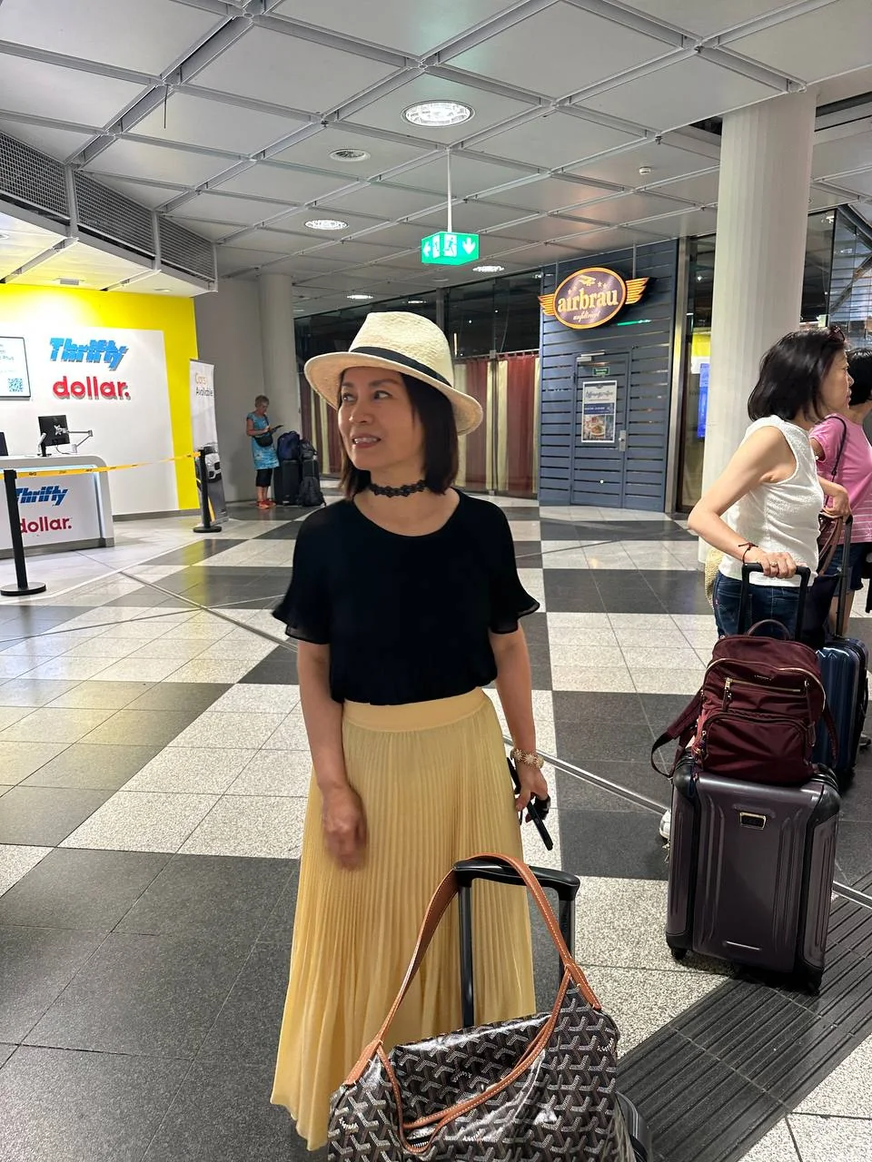 Traveler with luggage at the Munich Airport rental-car hall
