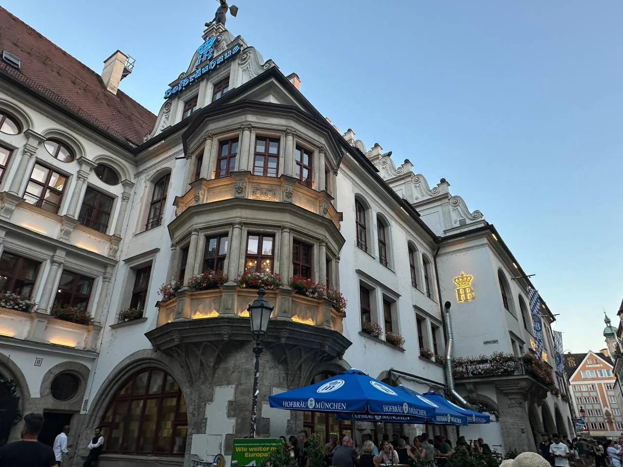 Decorated historic building on a lively Munich street