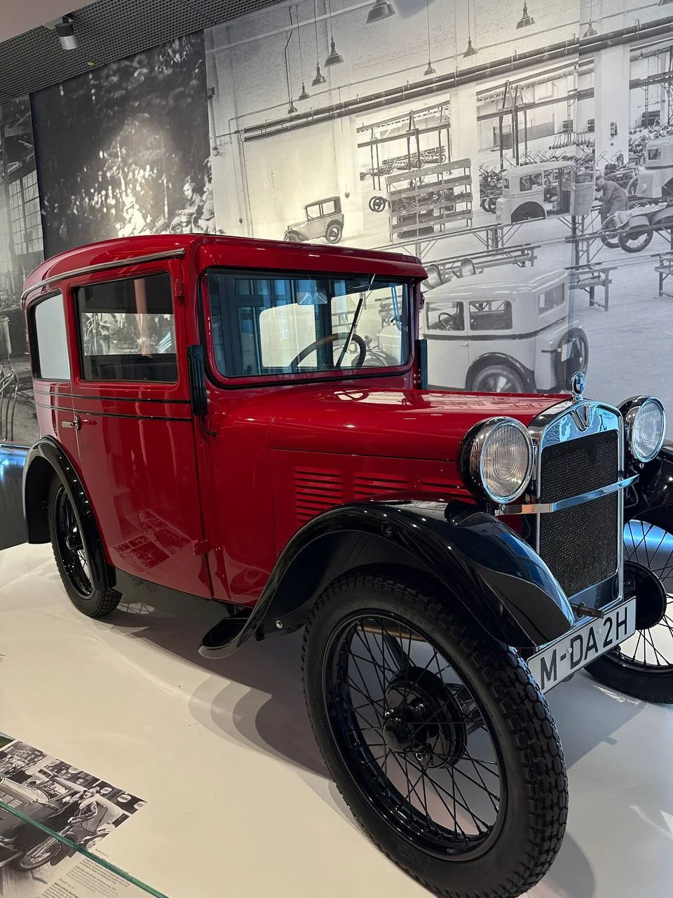 Red vintage BMW automobile displayed in the museum