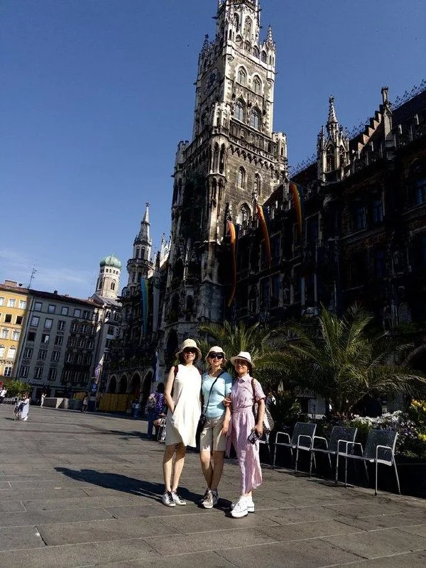 Friends posing together beside Munich New Town Hall