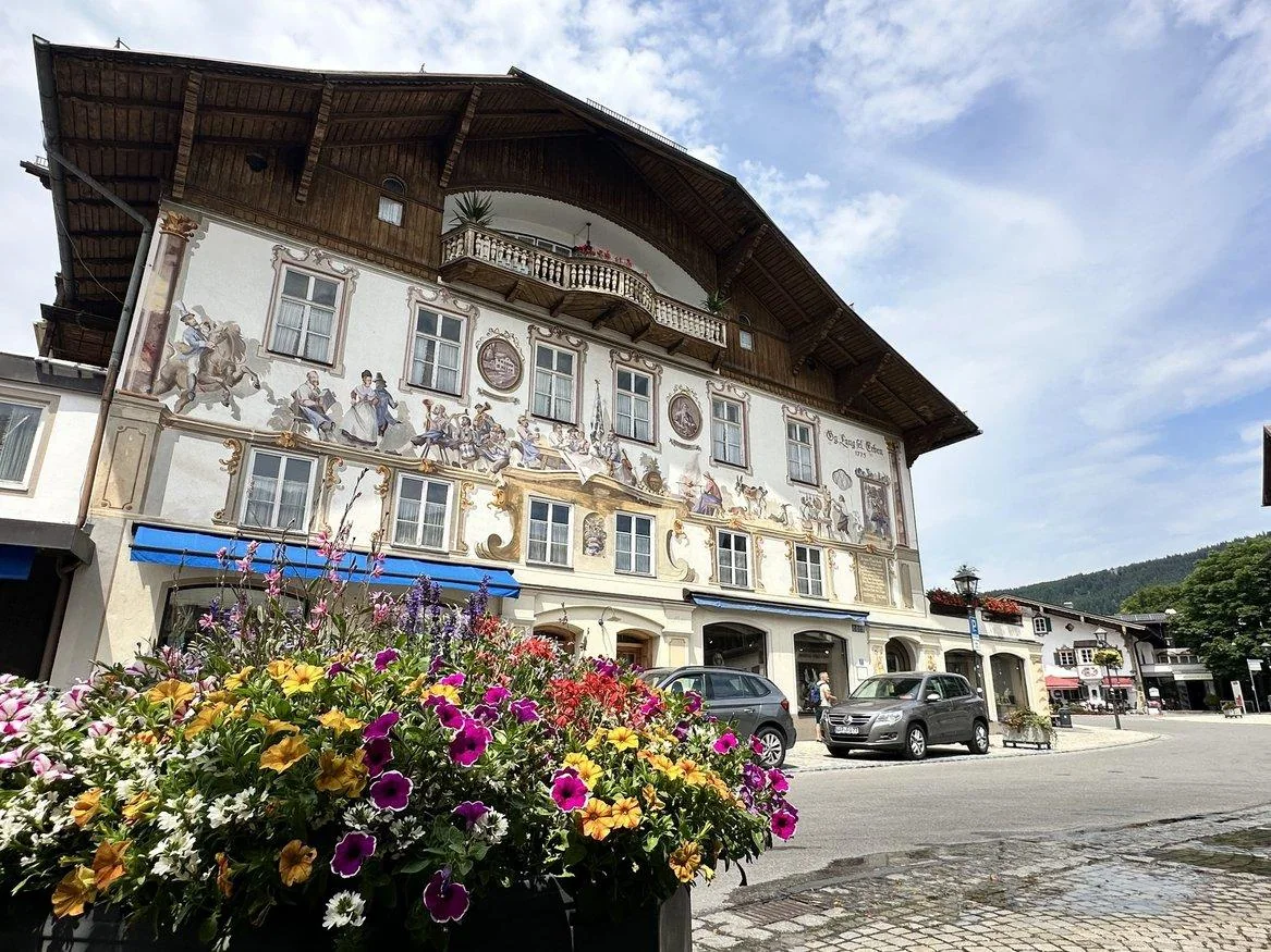 Painted Oberammergau house framed by colorful flowers