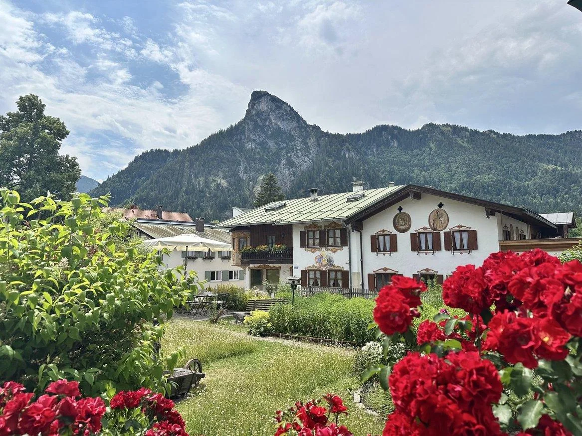 Oberammergau rooftops, flowers, and an alpine peak