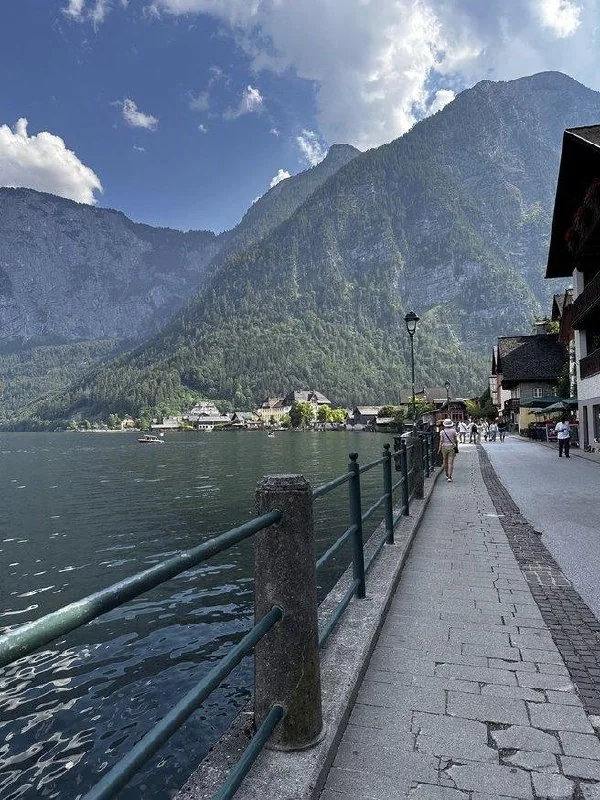 Hallstatt lakeside promenade beneath steep mountains