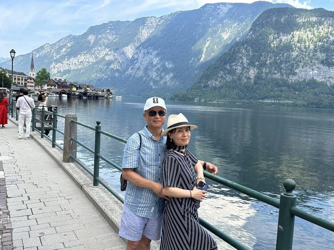 Couple standing together beside Hallstatt lake