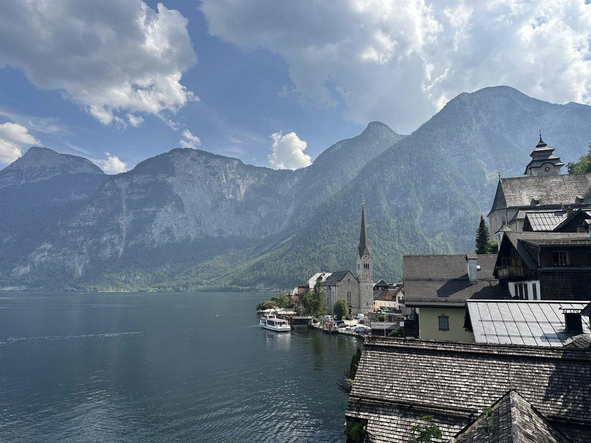 Classic Hallstatt view with lakeside houses, church tower, and mountains
