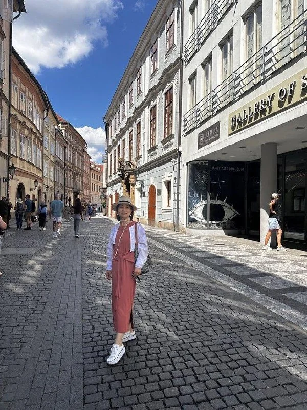 Traveler walking along a cobblestone street in Prague