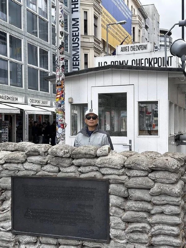 Traveler at the preserved Checkpoint Charlie guardhouse